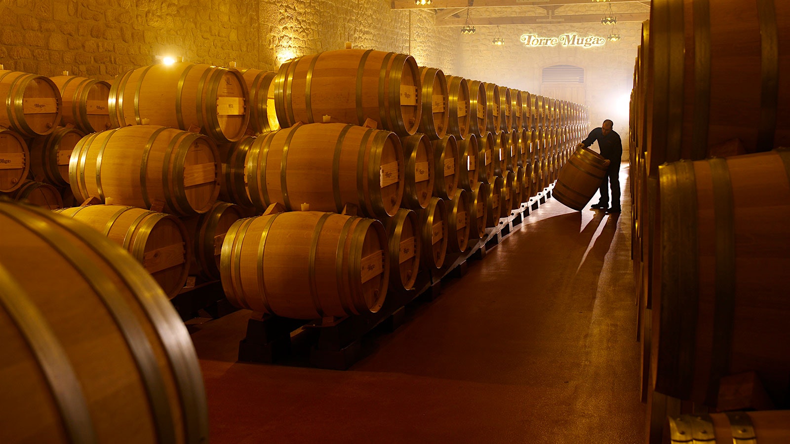 A worker moves barrels at Bodegas Muga in Rioja, Spain.